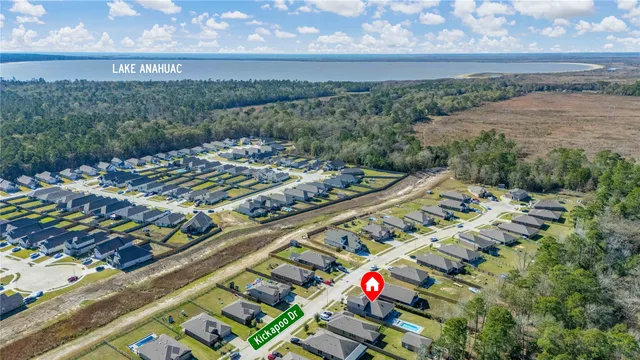 a view of house with swimming pool and sitting area