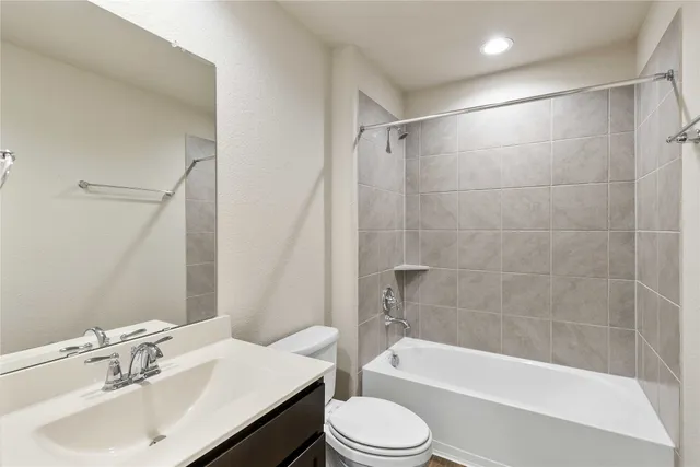 an empty room with a ceiling fan and window