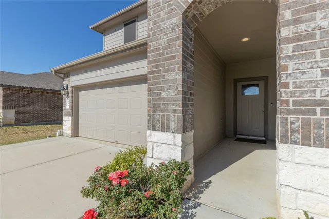 a view of swimming pool with seating area and trees in the background