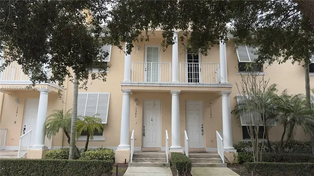front view of a house with a tree