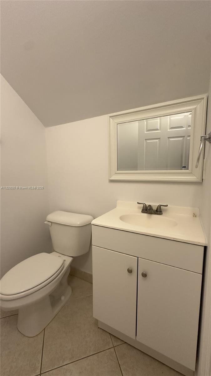 1587 Frederick Small Road Jupiter, FL 33458 - Photo 13 of 30 a bathroom with a sink a toilet and vanity