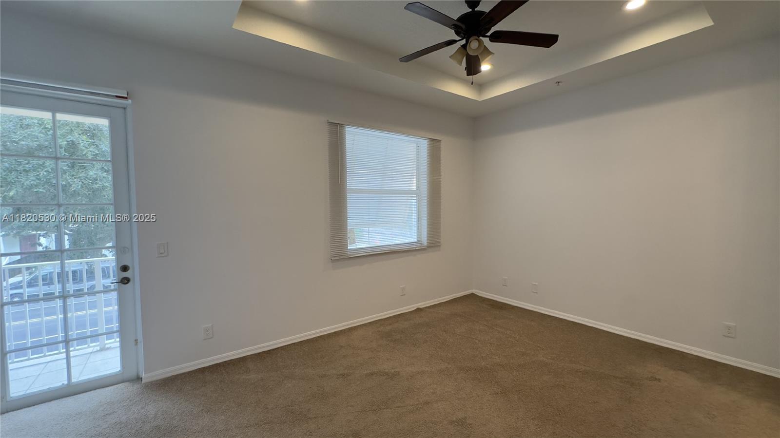 1587 Frederick Small Road Jupiter, FL 33458 - Photo 18 of 30 an empty room with windows and ceiling fan