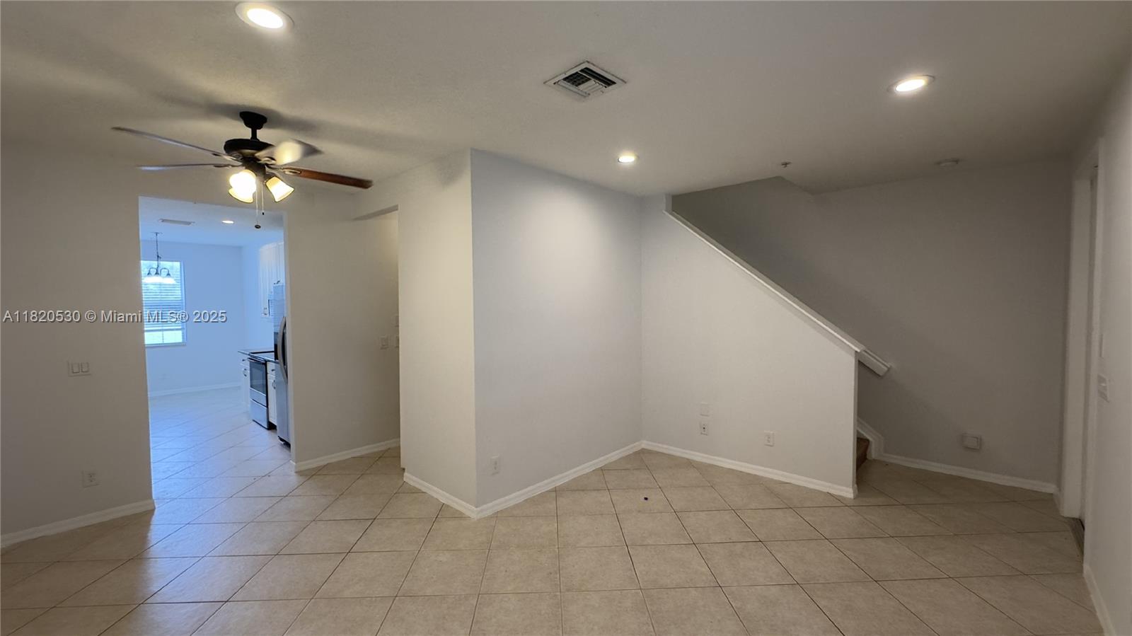 1587 Frederick Small Road Jupiter, FL 33458 - Photo 2 of 30 a view of a hallway with a chandelier fan and fire place