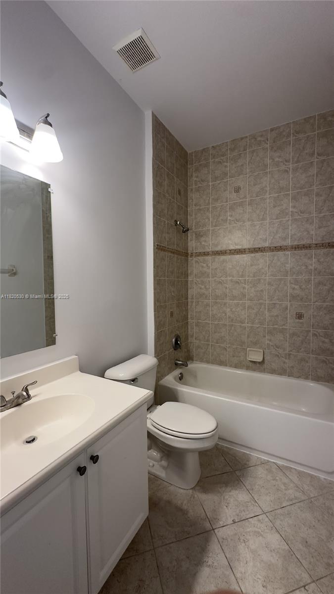 1587 Frederick Small Road Jupiter, FL 33458 - Photo 24 of 30 a bathroom with a sink a toilet and bathtub
