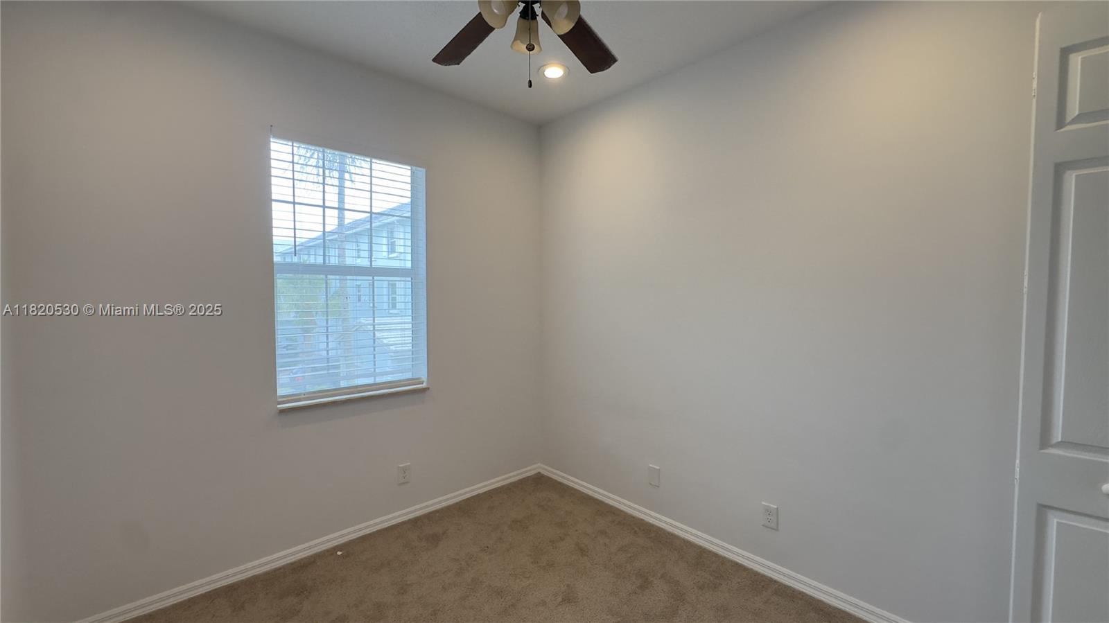 1587 Frederick Small Road Jupiter, FL 33458 - Photo 27 of 30 an empty room with windows and fan