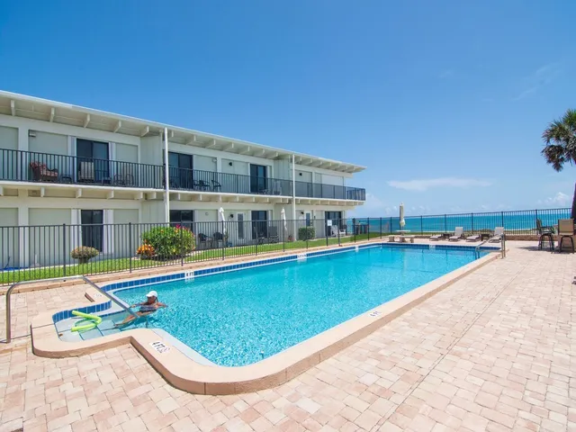 a view of swimming pool with outdoor seating