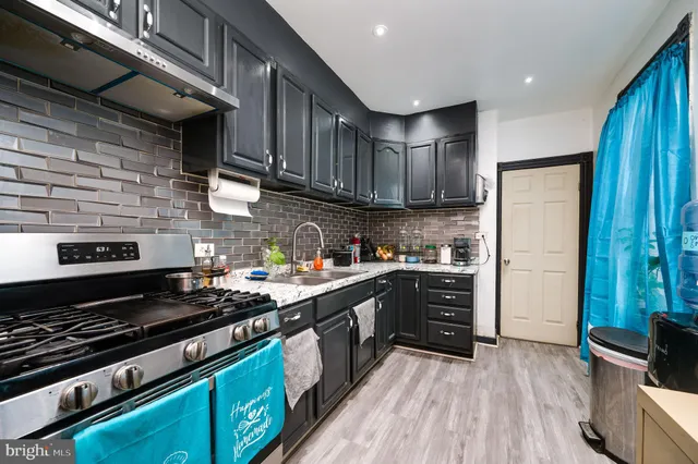 a kitchen with wooden cabinets and a stove top oven