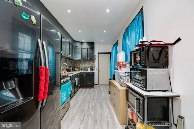 a kitchen with stainless steel appliances a stove and a refrigerator