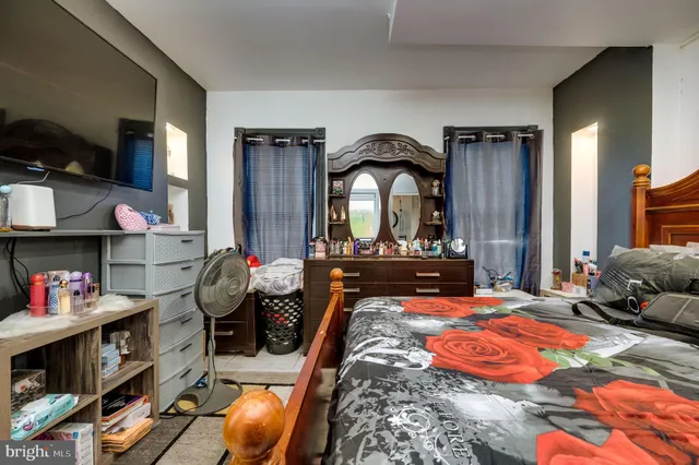 a bedroom with furniture and a closet