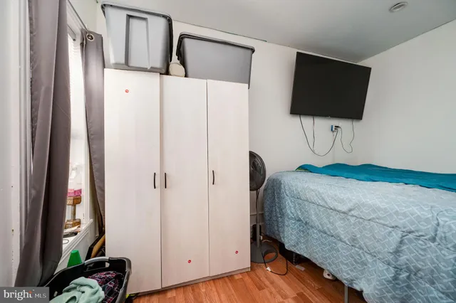a storage room with wooden floor washer and dryer