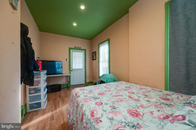 a bedroom with a bed and a tv
