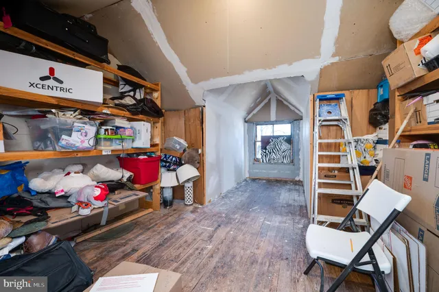 a view of a livingroom with furniture front door and wooden floor