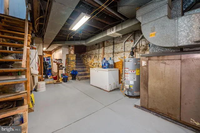 a backyard of a house with barbeque oven table and chairs