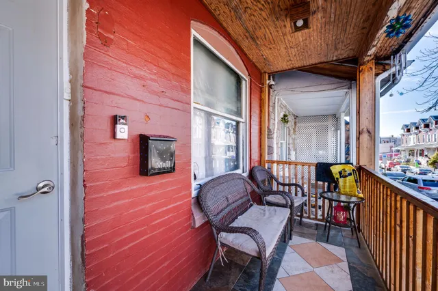 a balcony with furniture and a potted plant