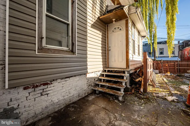 a backyard of a house with barbeque oven