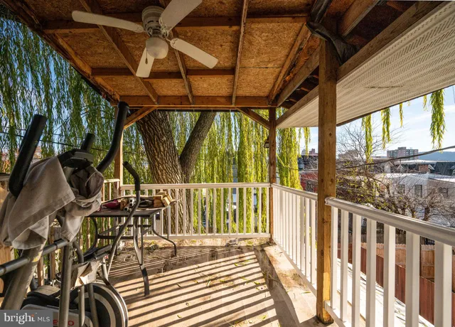 a view of balcony with chairs and potted plants
