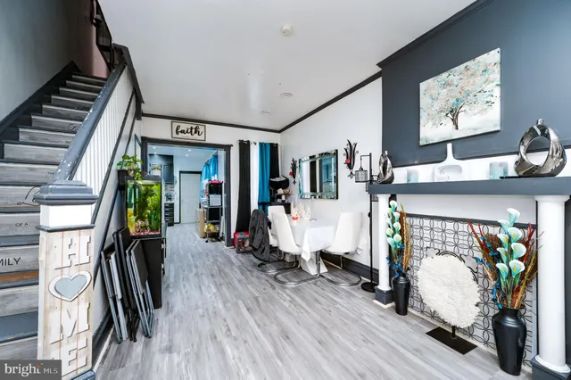 a living room with furniture a window and a flat screen tv