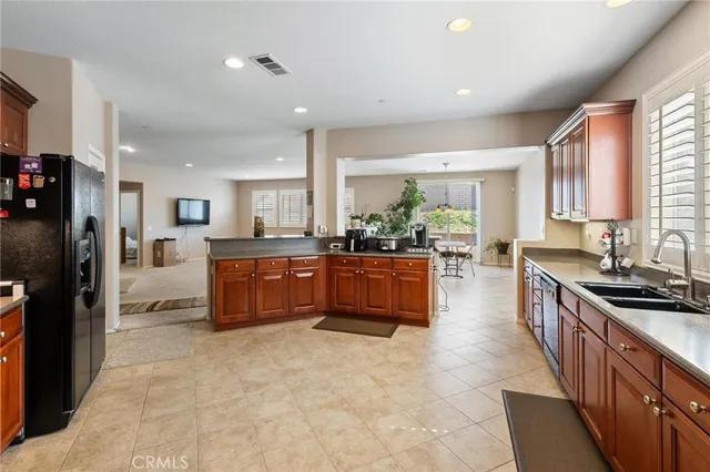 a kitchen with stainless steel appliances granite countertop a stove sink microwave and window