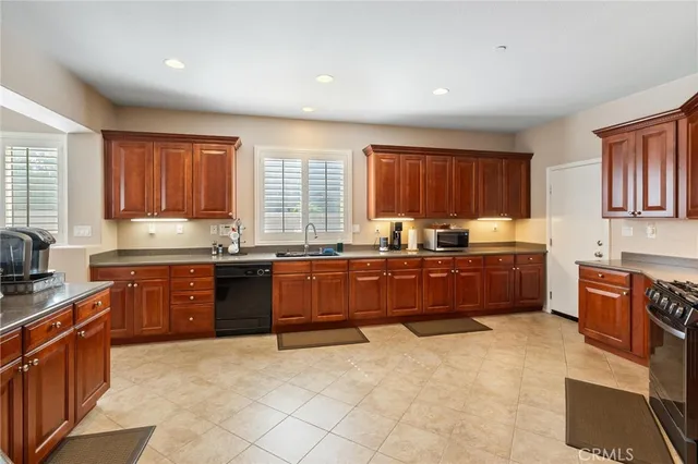 a kitchen with stainless steel appliances granite countertop a refrigerator stove and sink