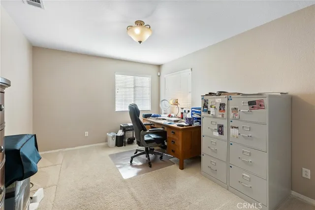 an empty room with sliding glass door and shower
