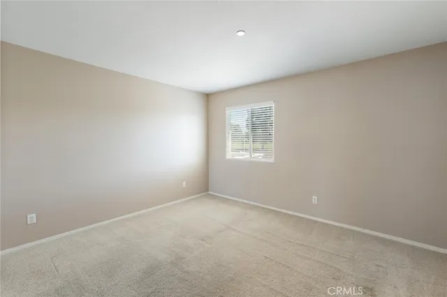 a spacious bedroom with a bed and a window