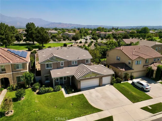 an aerial view of a house with garden space and street view