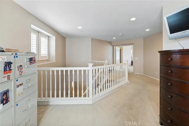 a view of a house with a yard and potted plants