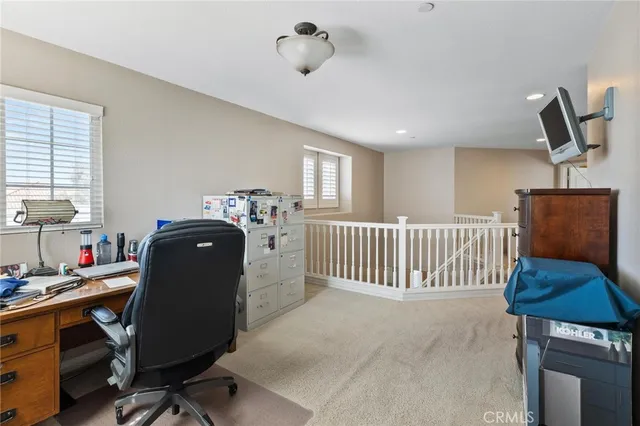 a front view of a house with a yard and potted plants