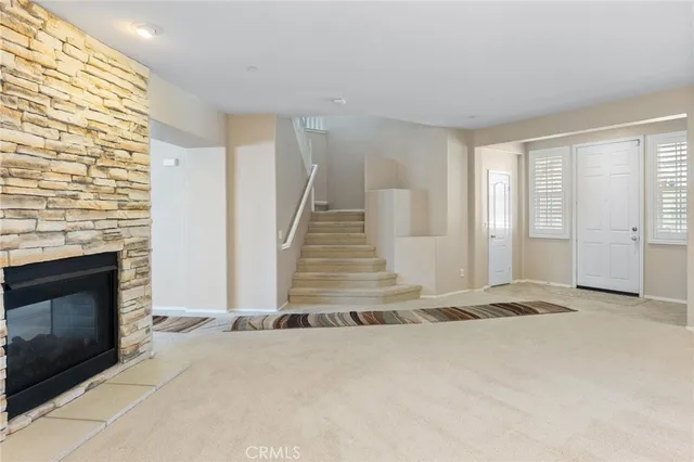 a view of a livingroom with wooden floor and a fireplace