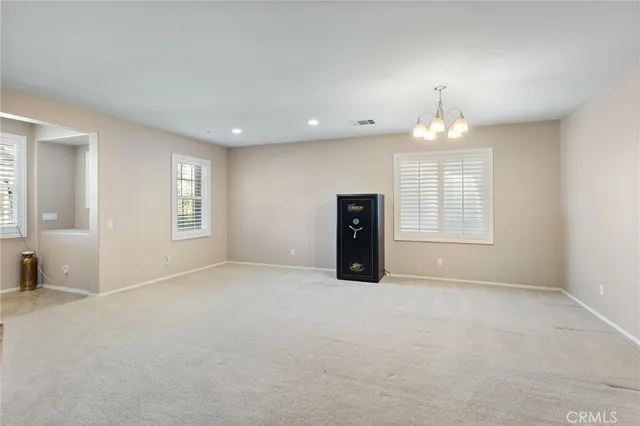 a view of an empty room with a fireplace and a window