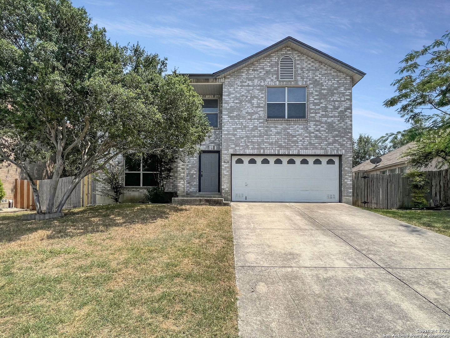 8618 Cross Spring San Antonio, TX 78251 - Photo 1 of 1 a front view of a house with a yard and garage