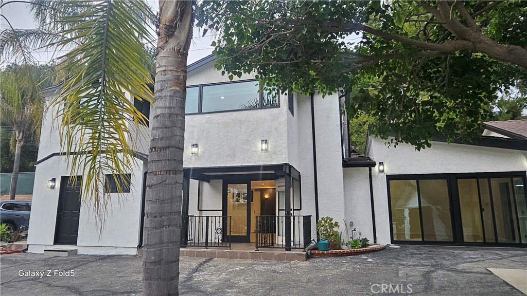 a view of a house with a tree
