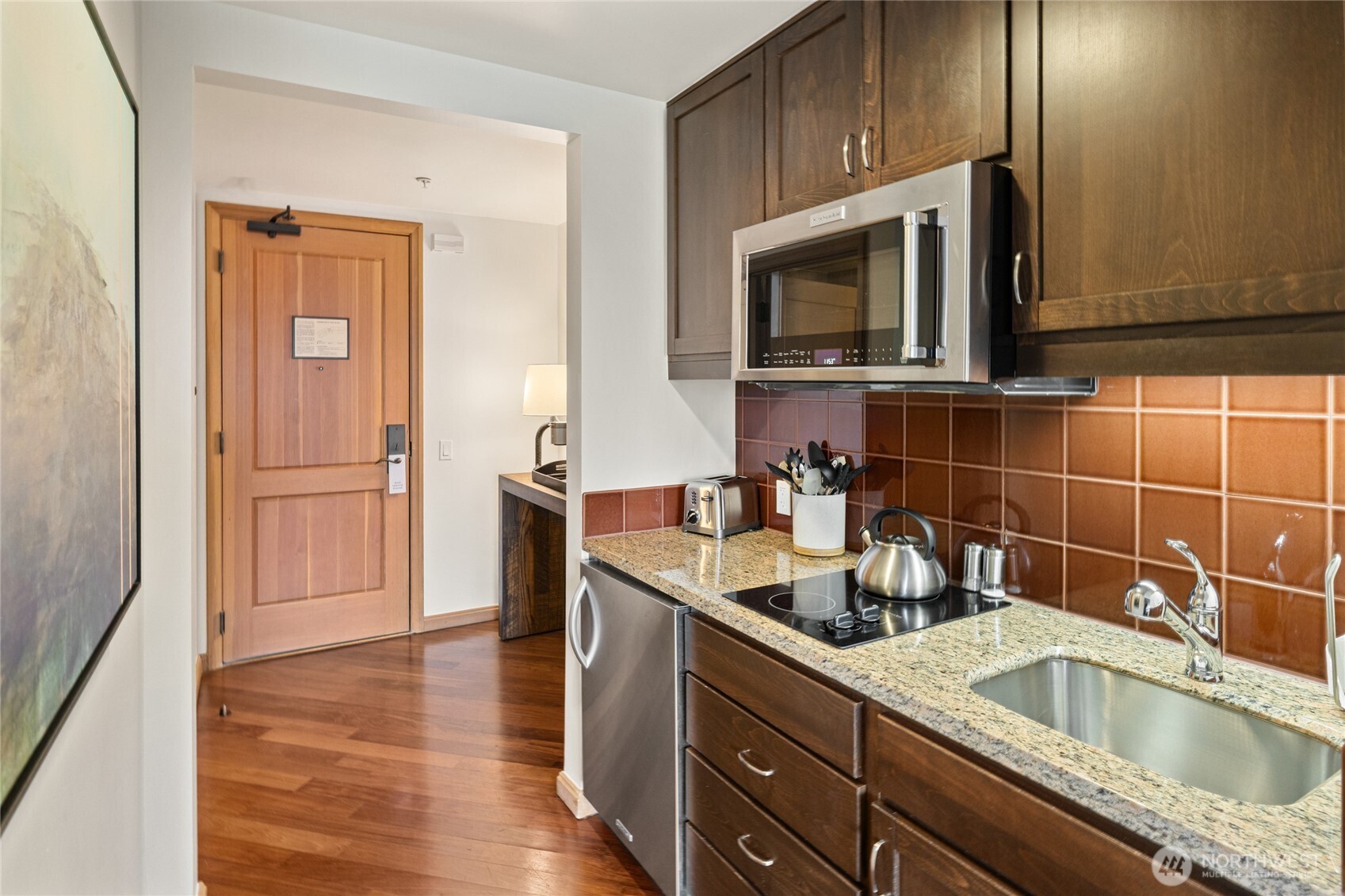 3600 Suncadia Trail, Unit 4049 Cle Elum, WA 98922 - Photo 21 of 26 a kitchen with a sink and a microwave with wooden floor