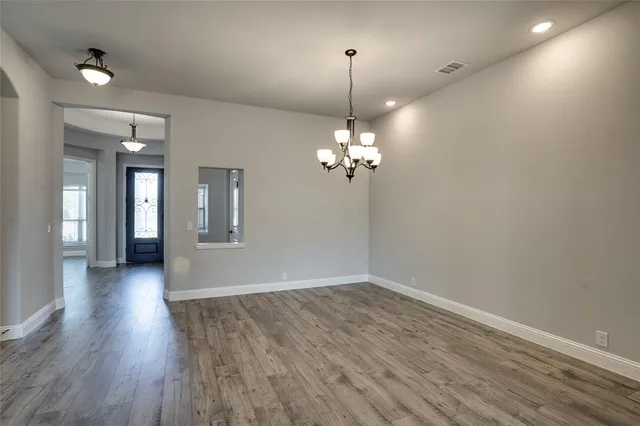 a view of livingroom with hallway and wooden floor