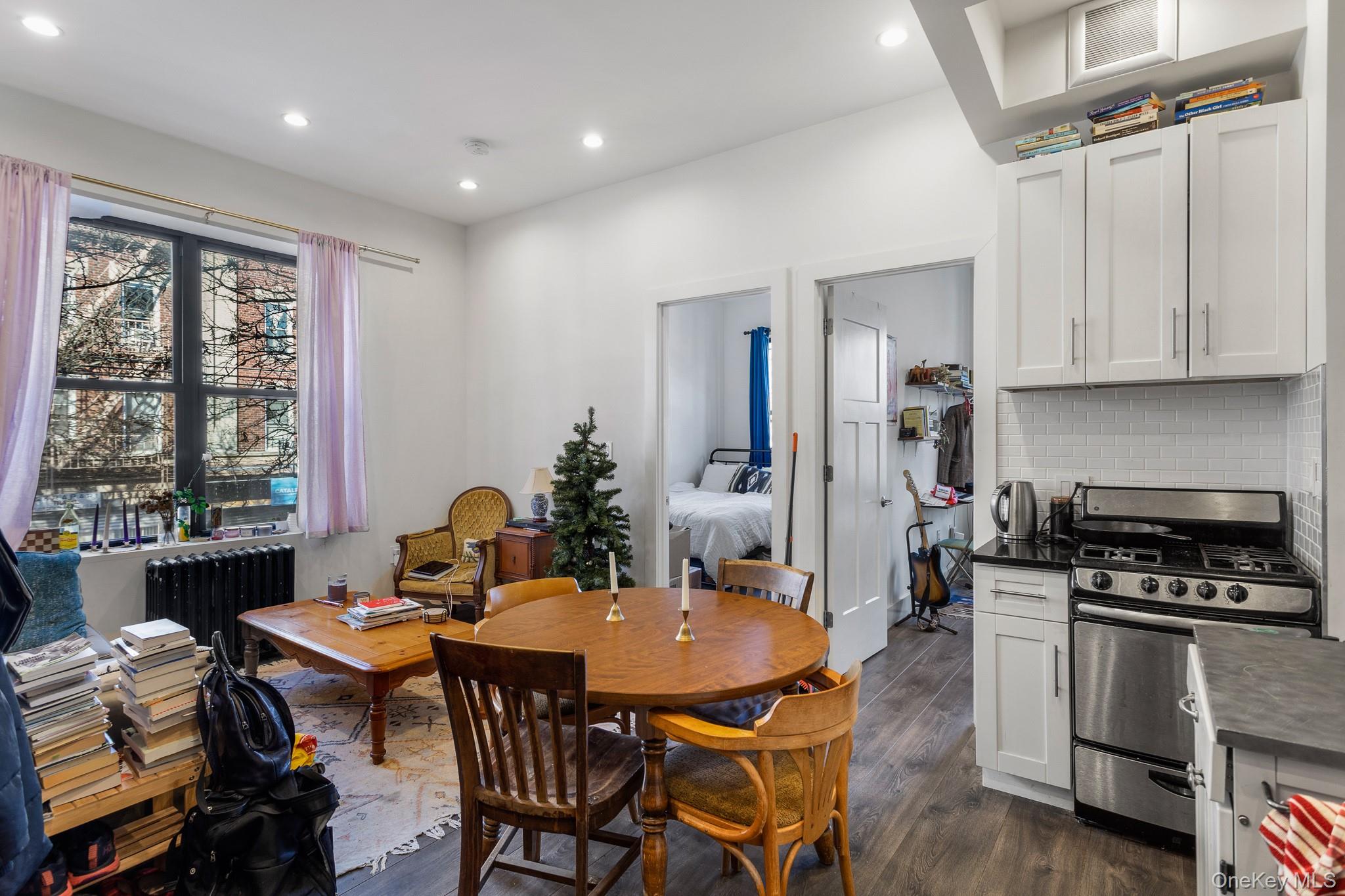 68-51 Fresh Pond Road, Unit 2B Queens, NY 11385 - Photo 1 of 15 Dining space featuring dark wood-style floors, radiator heating unit, and recessed lighting