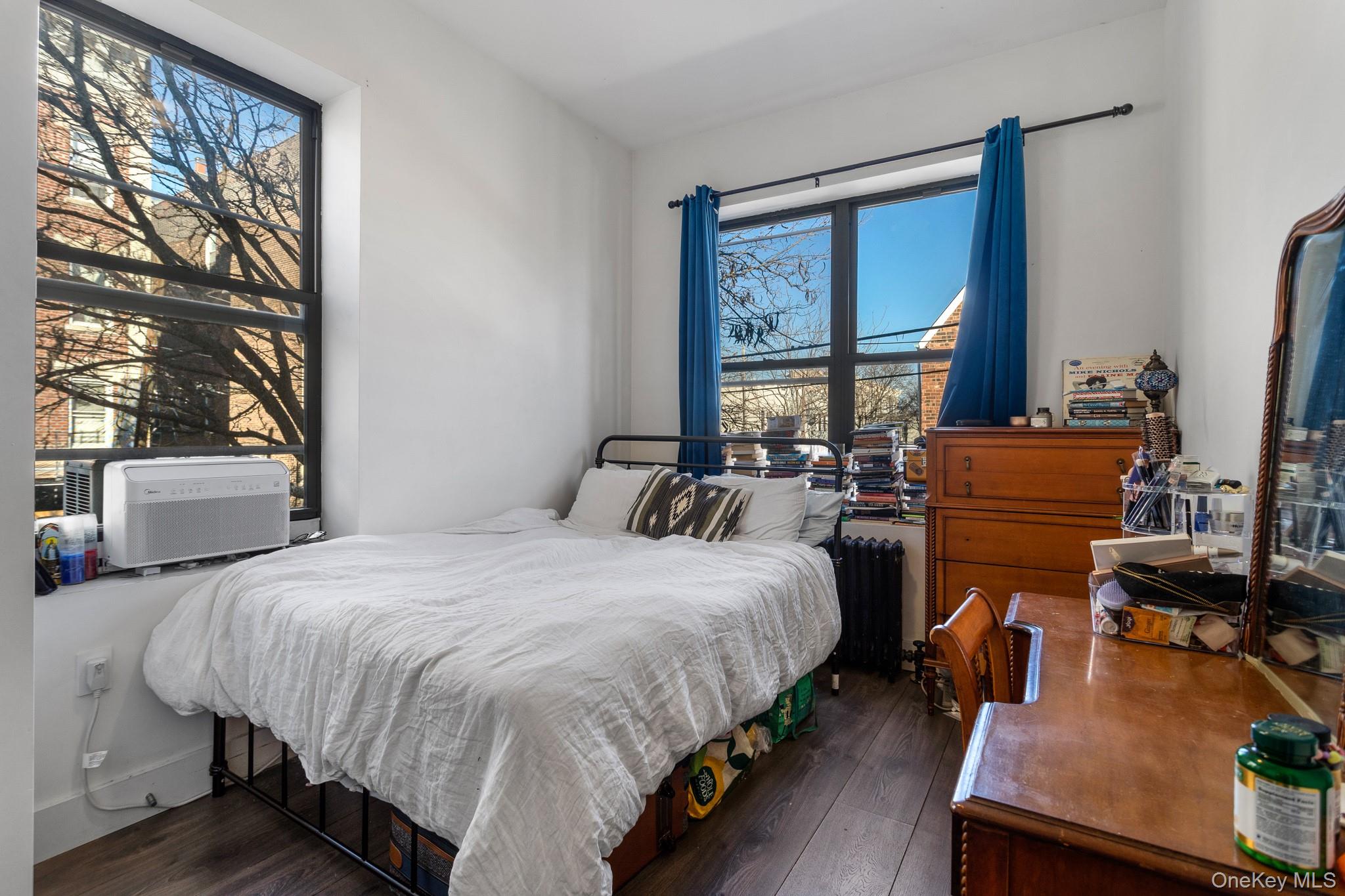 68-51 Fresh Pond Road, Unit 2B Queens, NY 11385 - Photo 7 of 15 Bedroom featuring dark wood finished floors, radiator, and cooling unit
