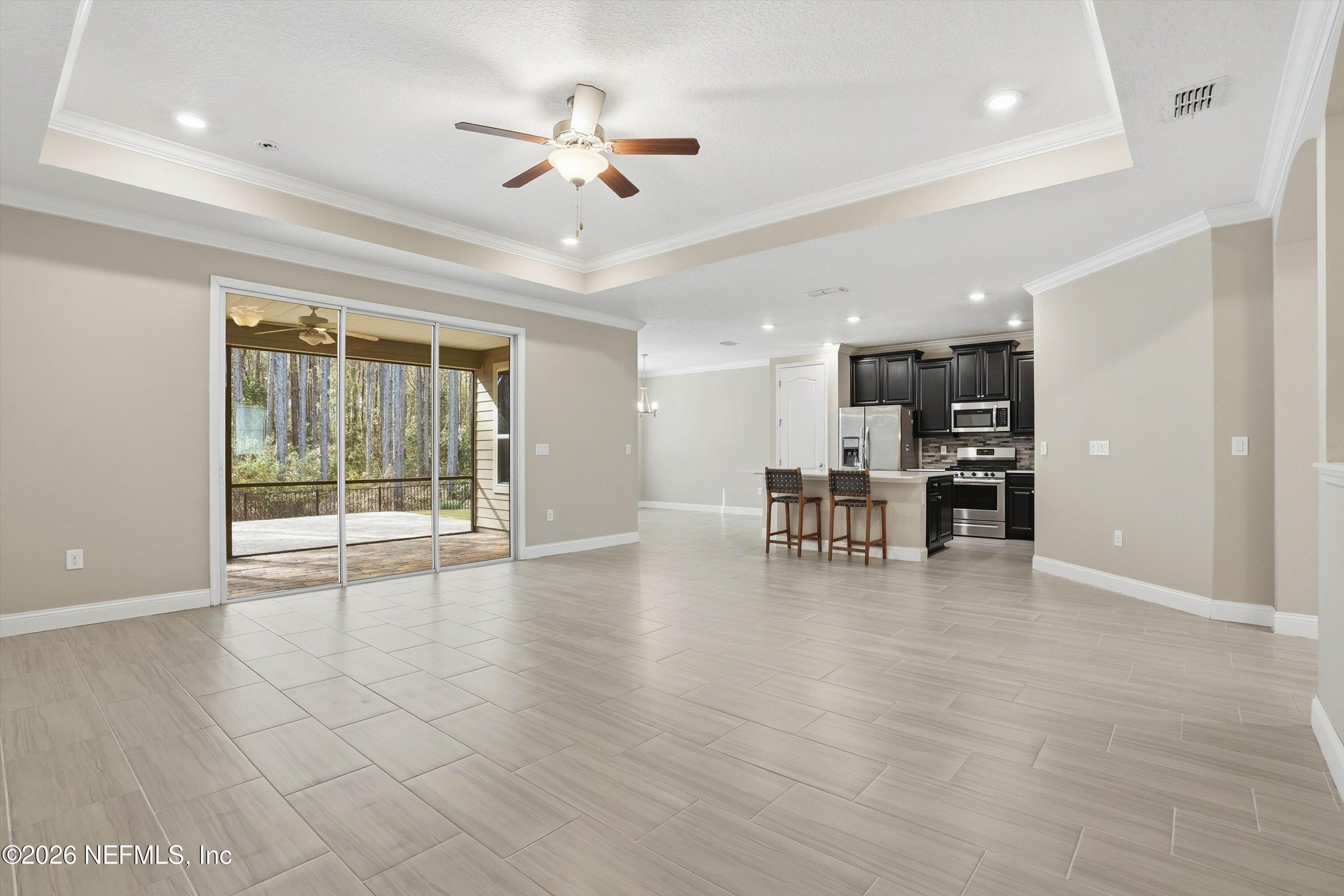 309 Coco Point St. Augustine, FL 32092 - Photo 11 of 50 a view of an empty room with a window and wooden floor