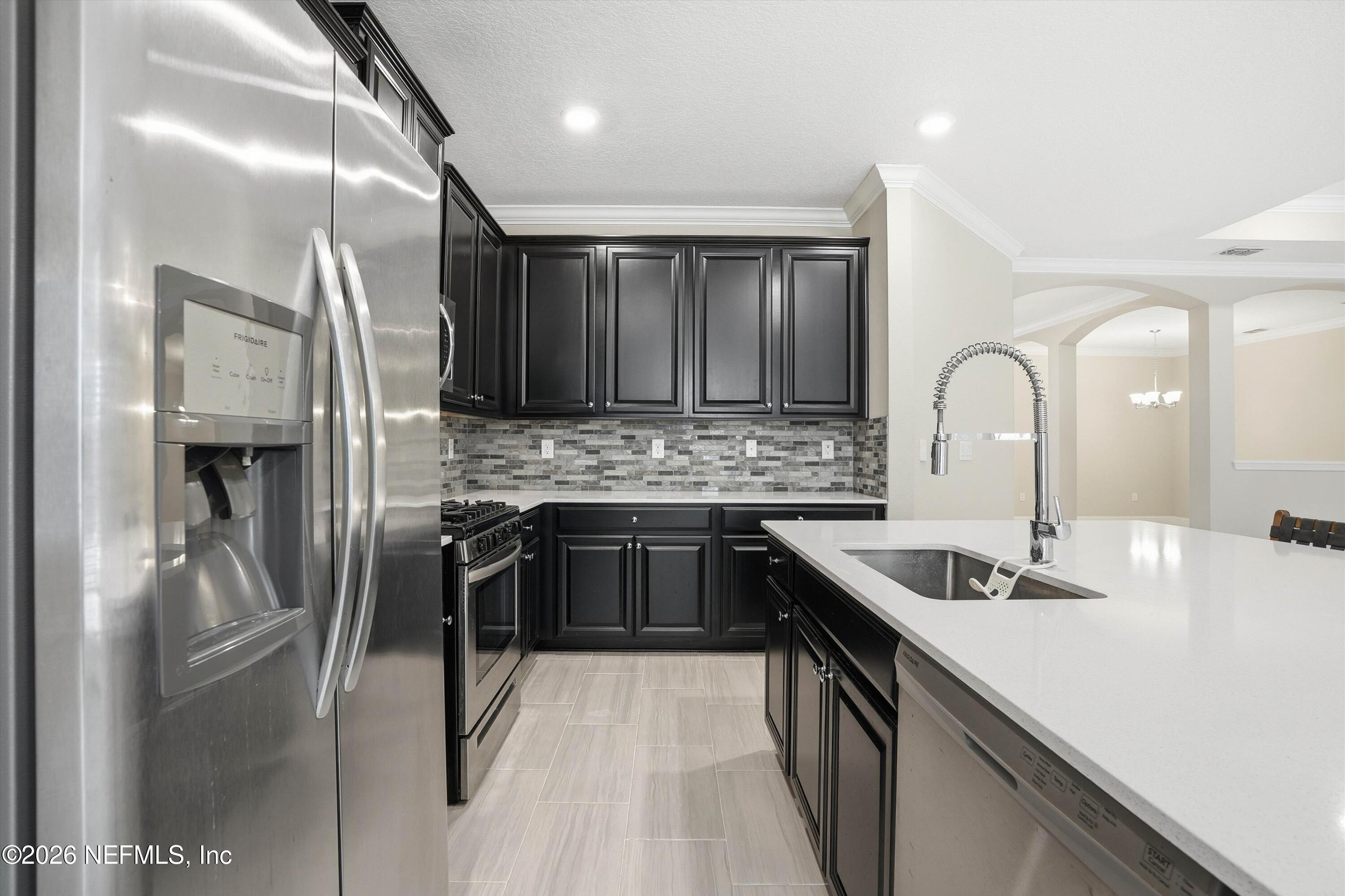 309 Coco Point St. Augustine, FL 32092 - Photo 16 of 50 a kitchen with stainless steel appliances granite countertop a sink refrigerator and cabinets