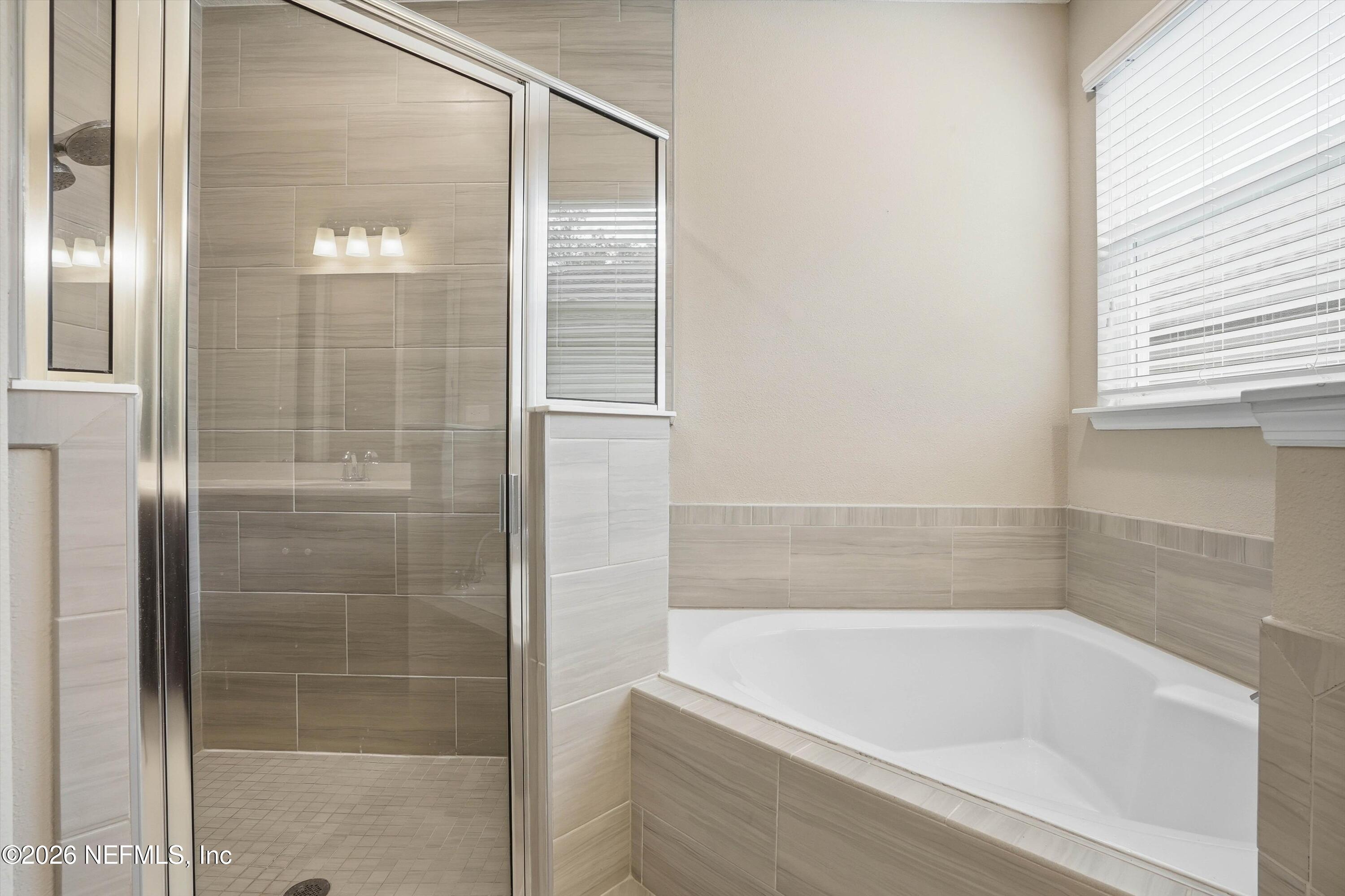 309 Coco Point St. Augustine, FL 32092 - Photo 25 of 50 a bathroom with a bathtub and a shower