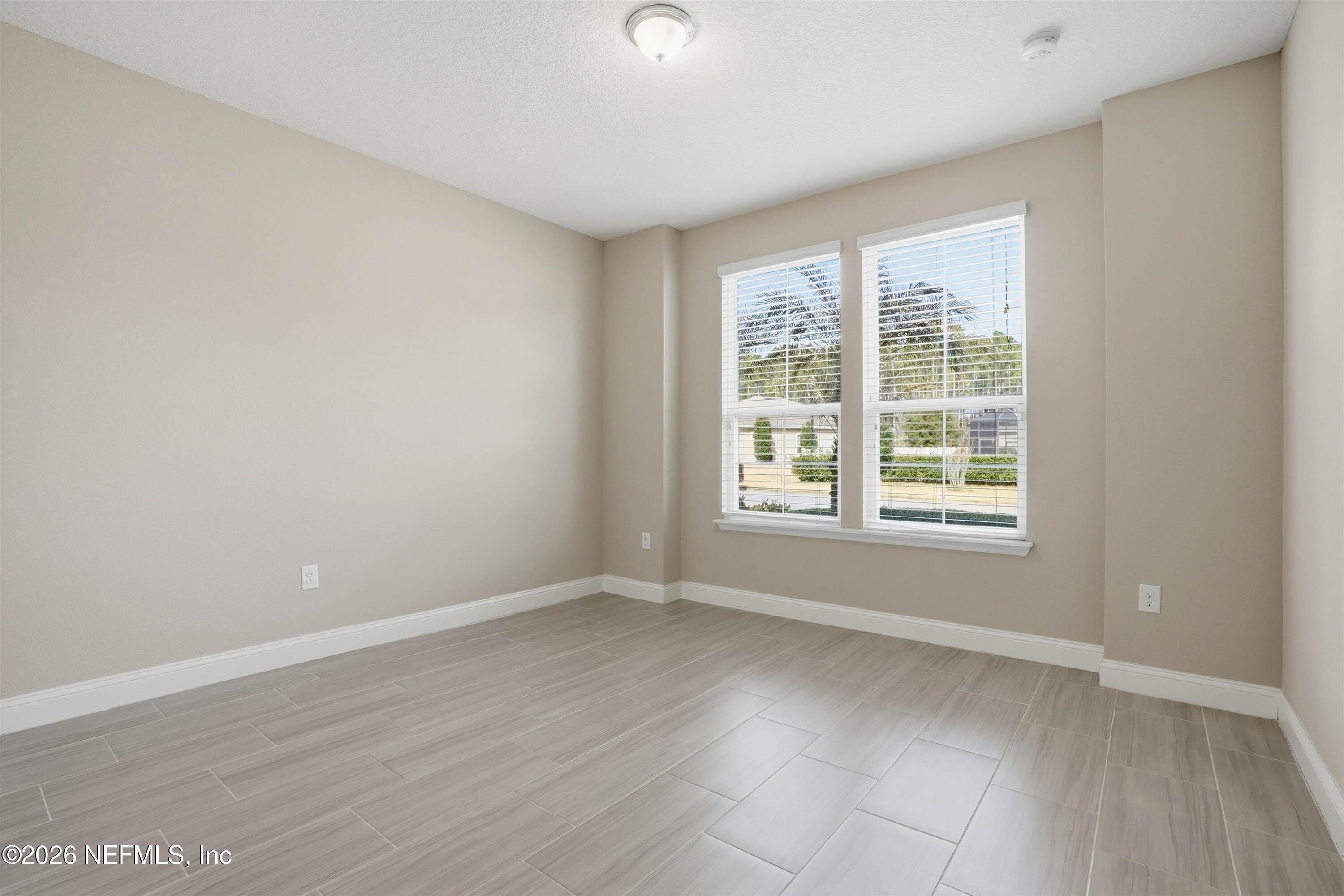309 Coco Point St. Augustine, FL 32092 - Photo 31 of 50 an empty room with wooden floor and windows