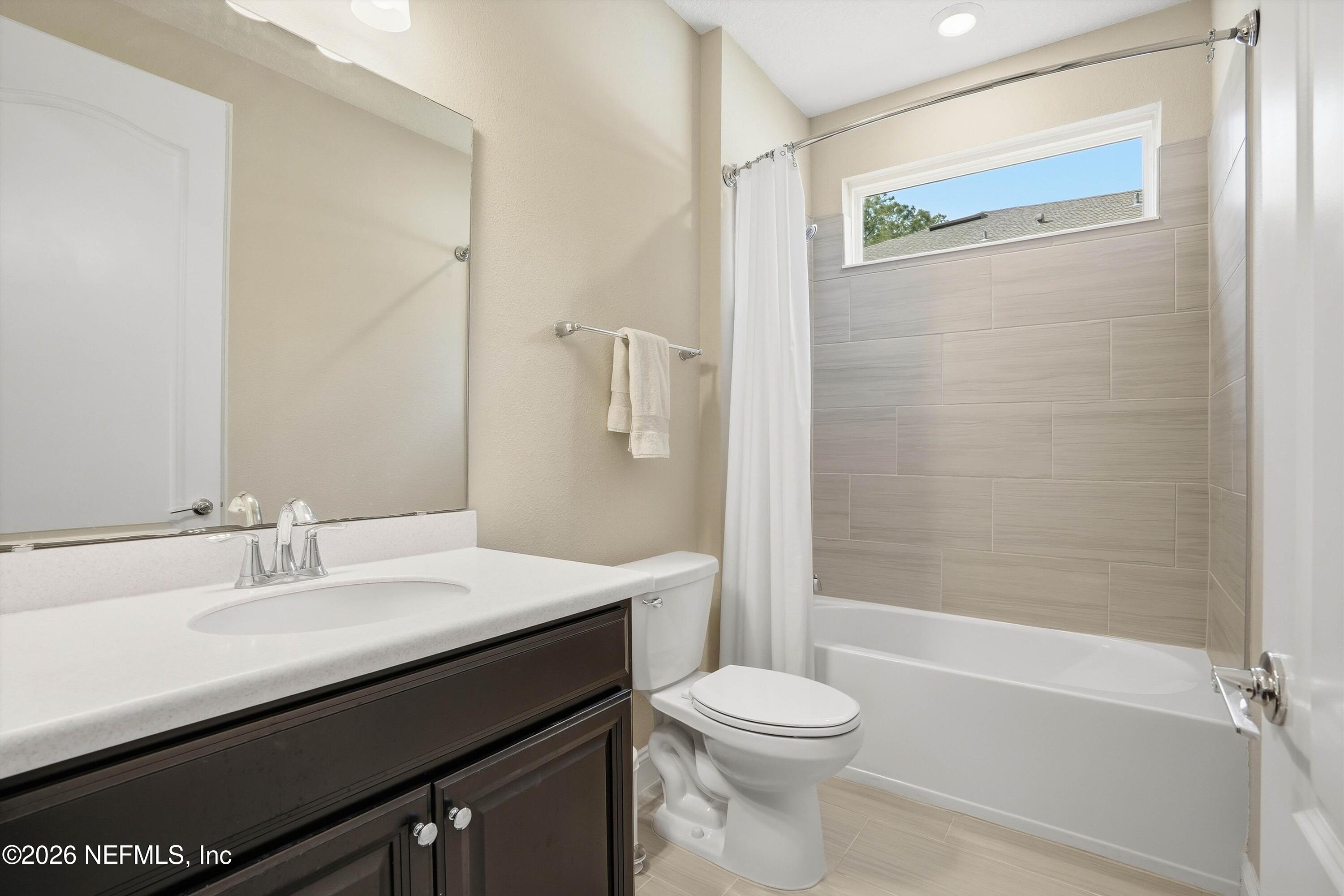 309 Coco Point St. Augustine, FL 32092 - Photo 32 of 50 a bathroom with a sink a toilet and shower