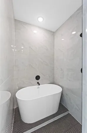 a bathroom with a sink a toilet a mirror and shower