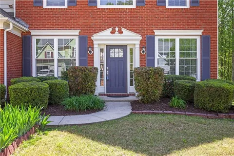 a front view of a house with garden