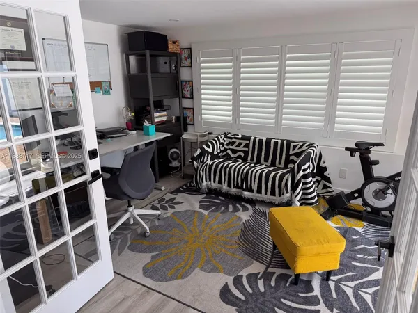 a bedroom with furniture and a wooden floor