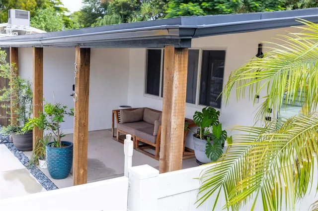 a view of a porch with furniture and garden