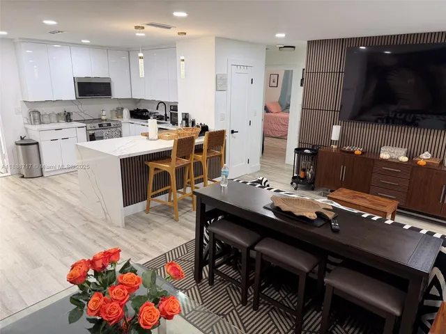 a kitchen with a sink a stove and wooden floor