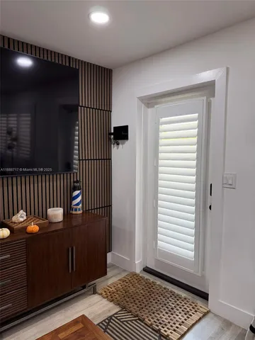 a kitchen with a refrigerator and a stove top oven