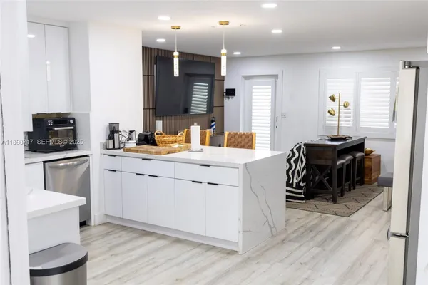 a kitchen with a refrigerator and a stove top oven