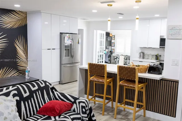 a kitchen with stainless steel appliances a refrigerator and a sink