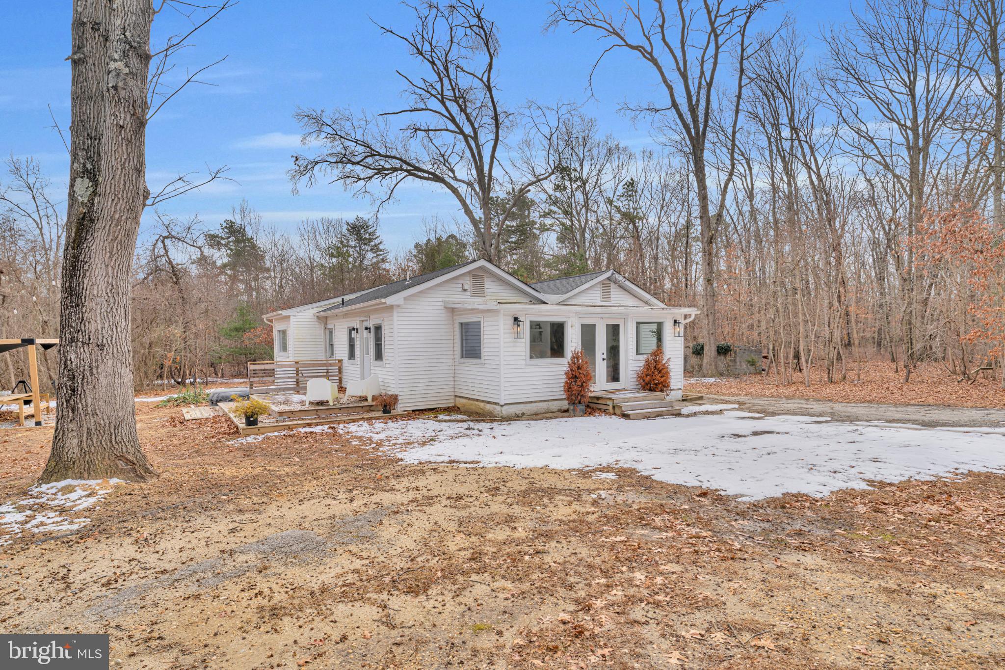 a view of a house with snow on the road
